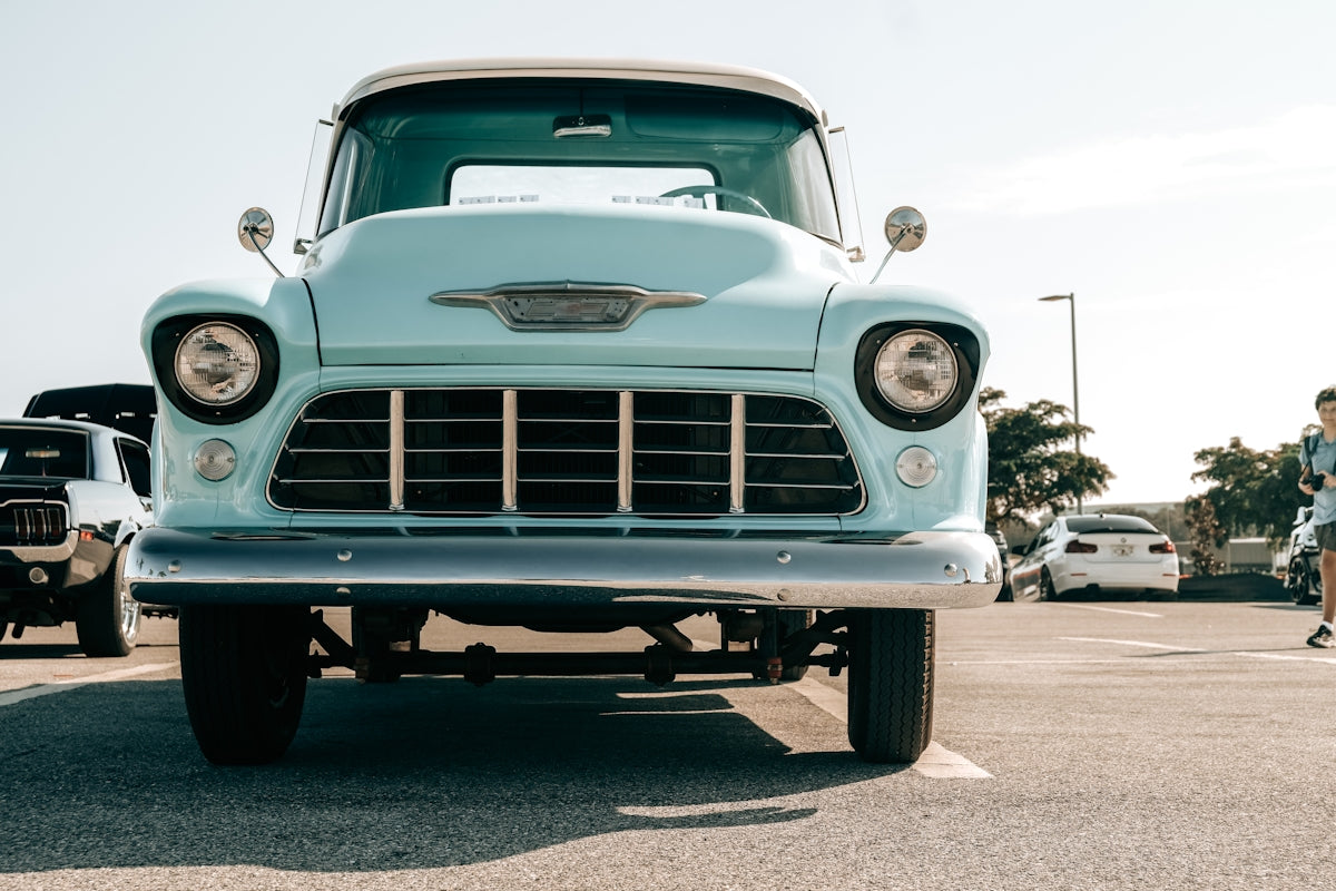Vintage light blue pickup truck parked outdoors