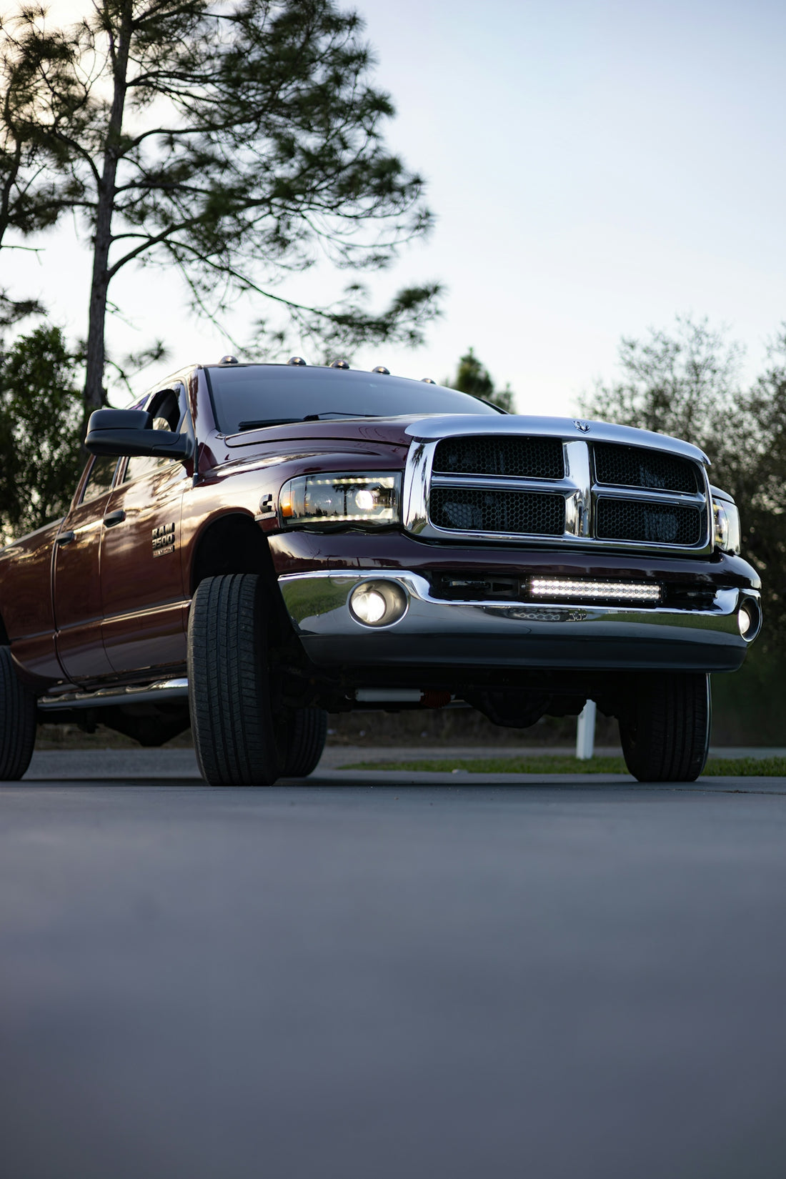 Maroon pickup truck with chrome accents and led bar.