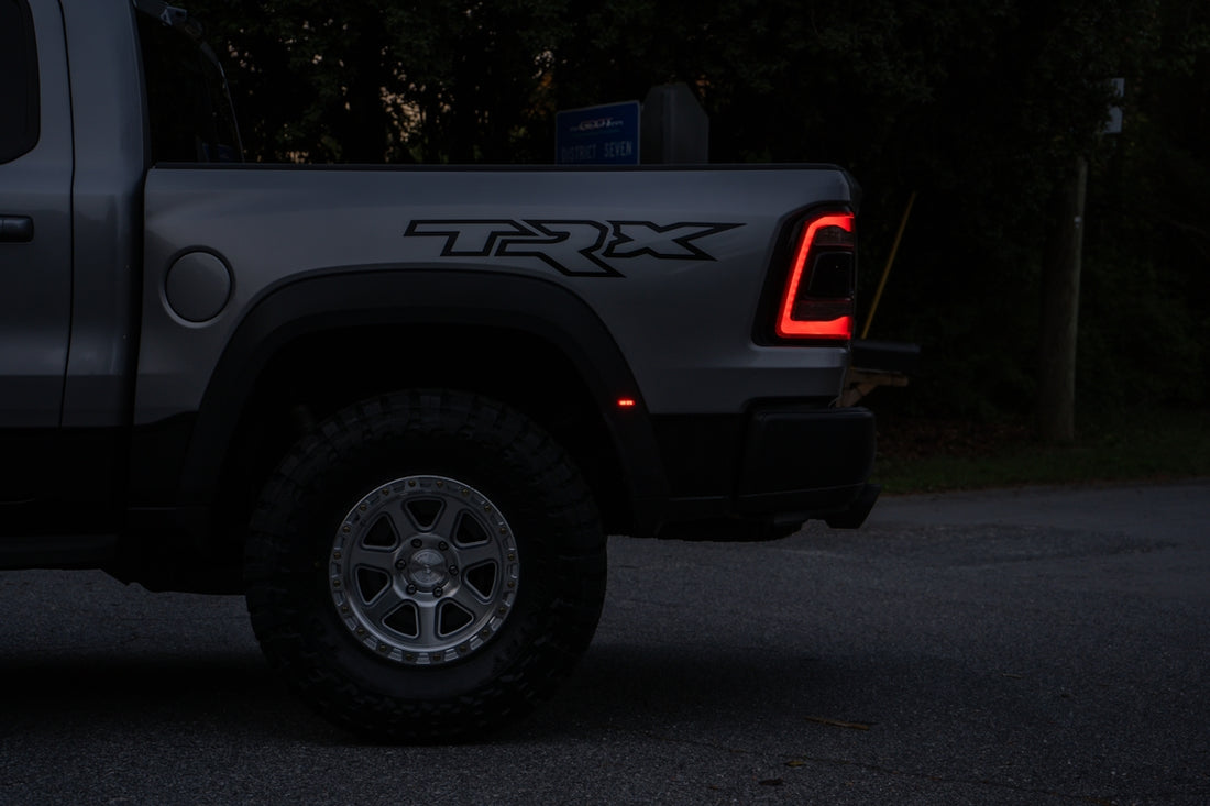 Silver pickup truck with trx logo at night