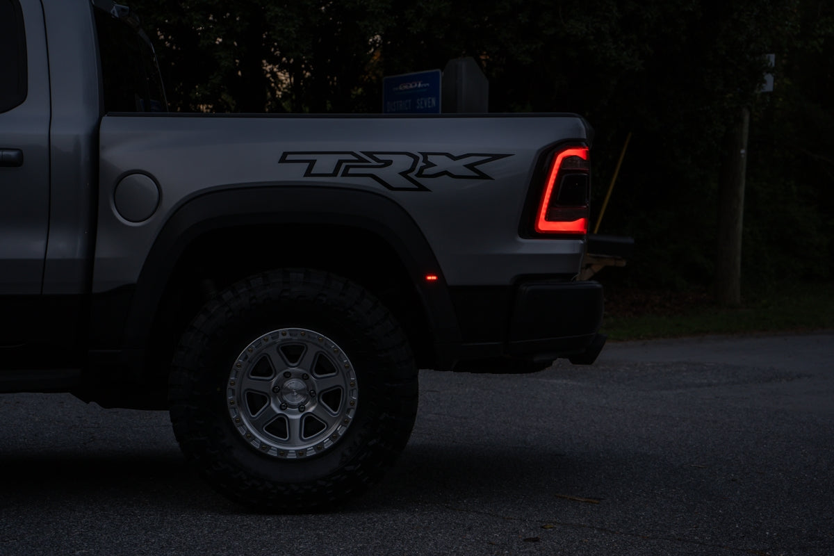 Silver pickup truck with trx logo at night